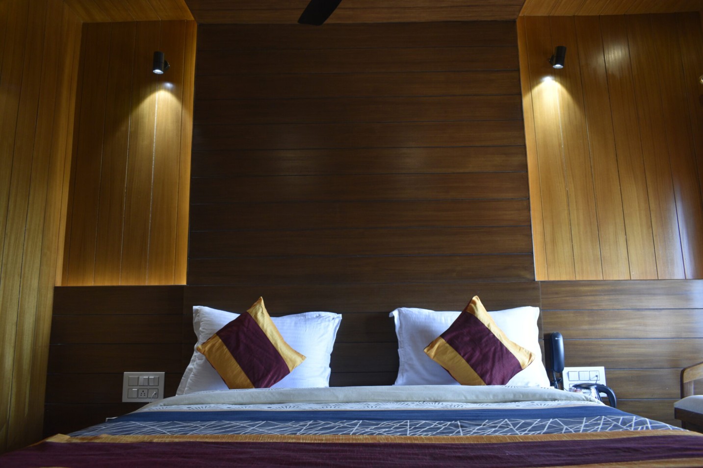 Luxury bedroom at Shivalaya Resort by Botanix featuring wooden interiors, elegant lighting, and cozy bedding for a serene mountain retreat.